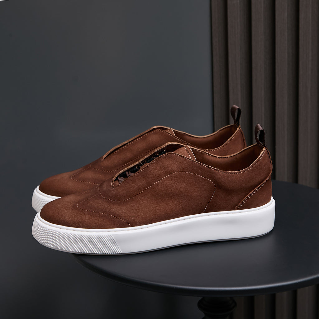 Dark brown leather sneakers with lace-up front and white rubber sole