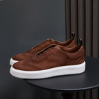 Dark brown leather sneakers with lace-up front and white rubber sole