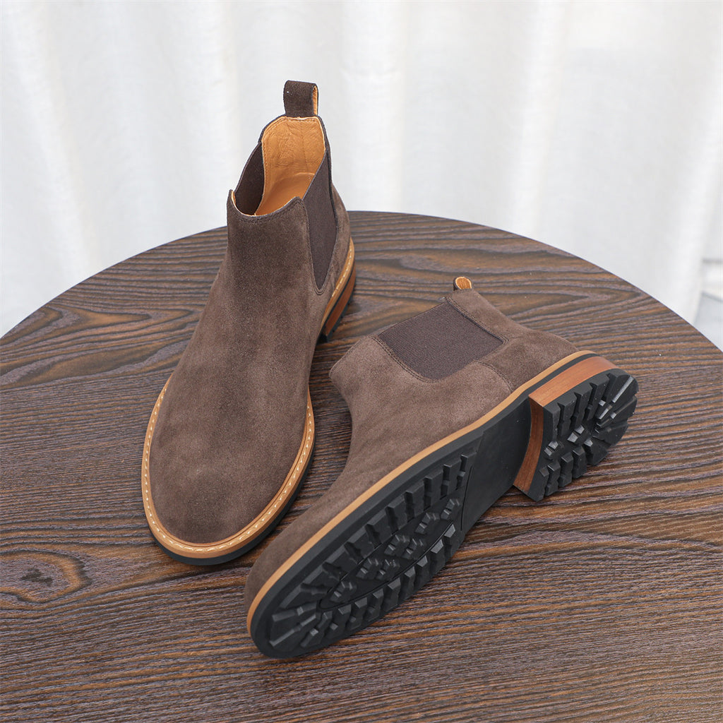 Men's suede chelsea dress boots in dark brown with treaded outsole view and side elastic