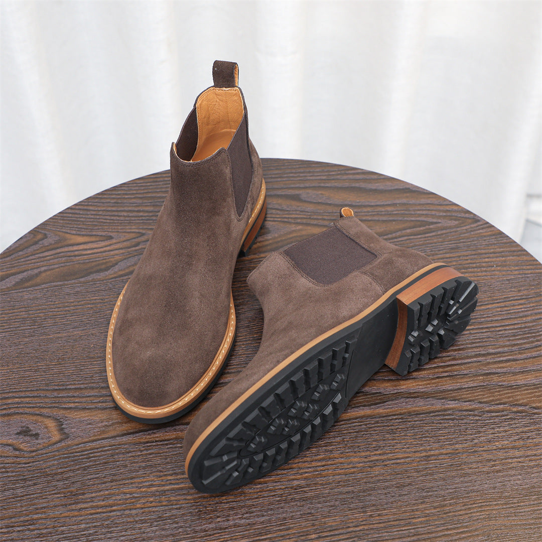 Men's suede chelsea dress boots in dark brown with treaded outsole view and side elastic