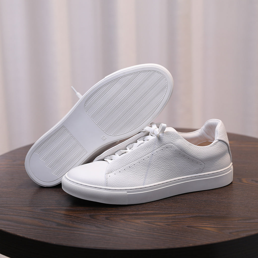 Men's genuine leather sneakers, white outsole and toe view with textured tread
