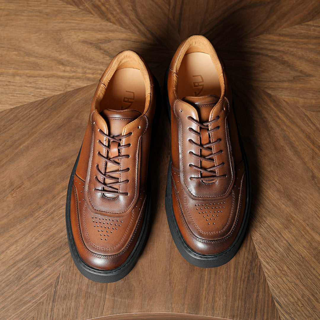 Dark brown leather sneakers with lace-up closure, perforated toe, and padded collar.
