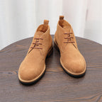 Pair of tan-brown lace-up chukka boots with suede upper and side seam detail.