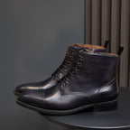 Men's dark leather lace-up dress boot angled view with pointed toe and padded collar