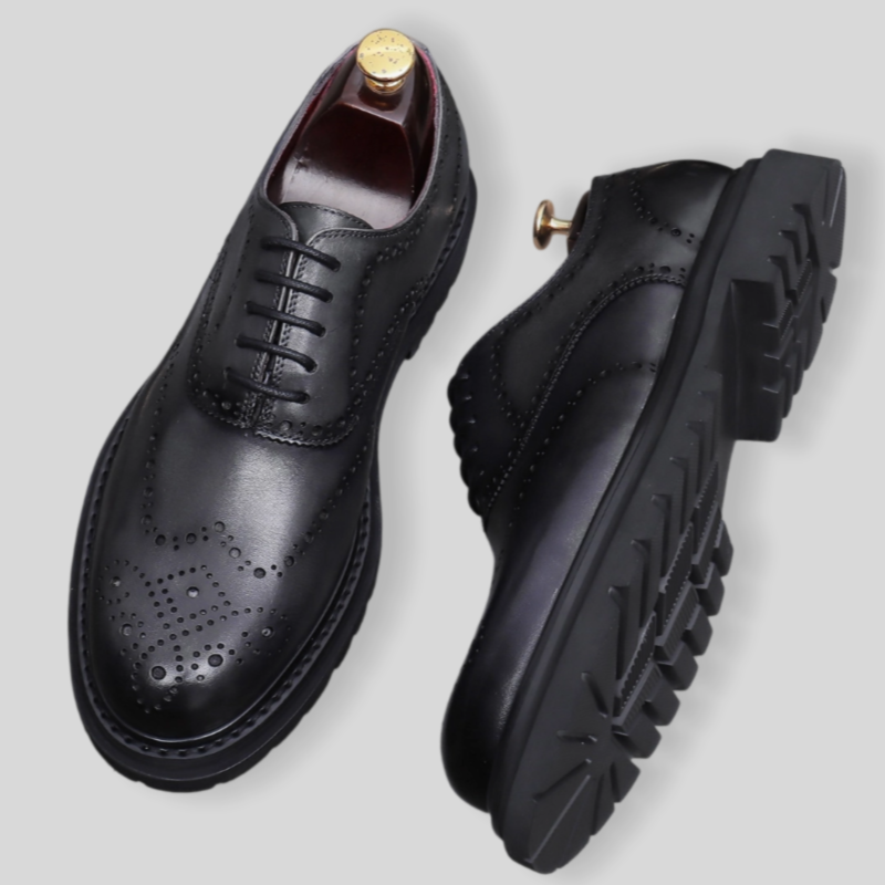 Black men's wingtip brogue Oxford shoes with chunky lug sole and lace-up closure