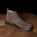 Men's suede chukka boots, plain toe, lace-up closure, taupe/brown, thick tread outsole.