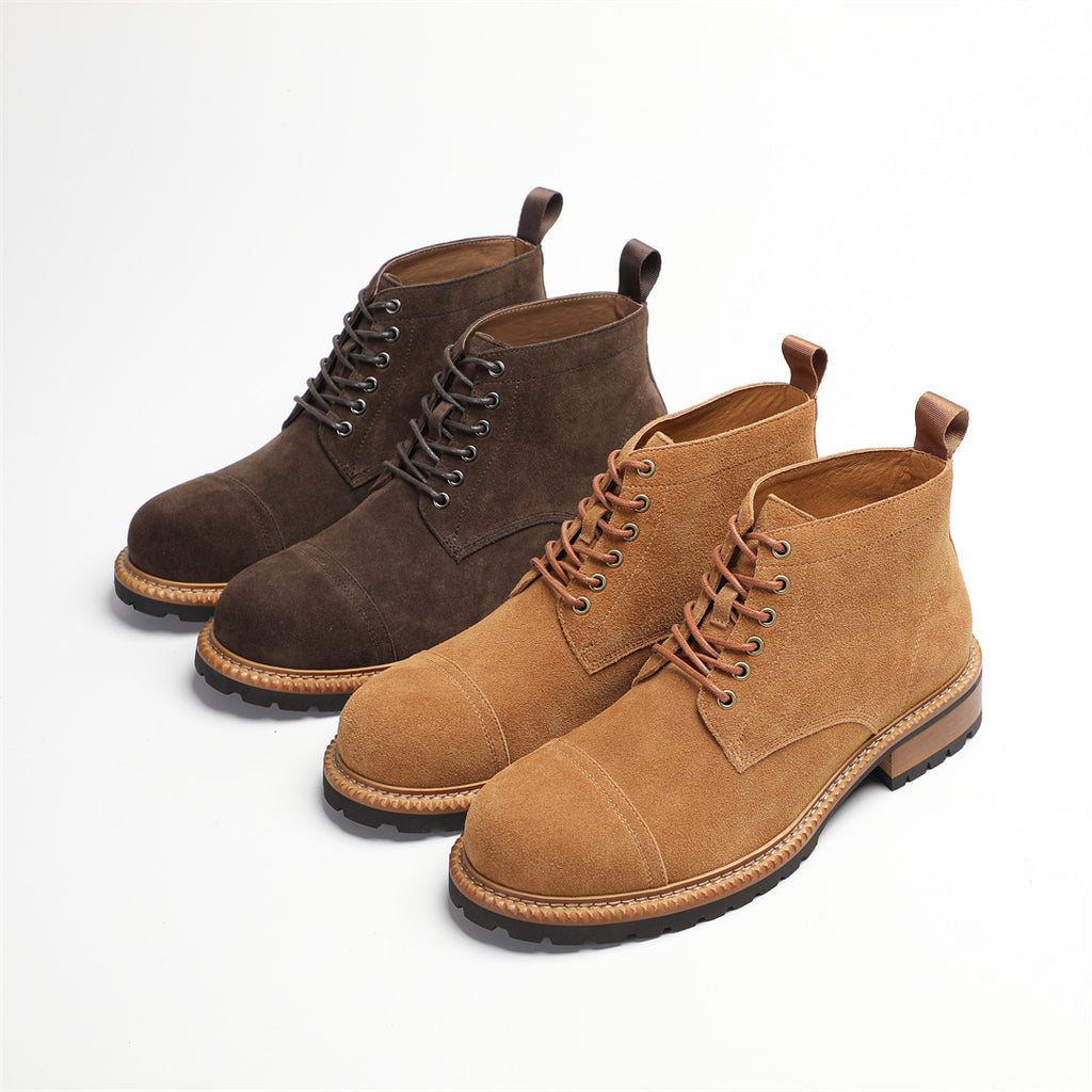 Pair of men's suede chukka boots in dark brown and tan, lace-up with low heel sole
