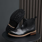 Men's pointed-toe suede Chelsea dress boots, black, outsole view with tread pattern