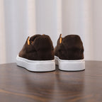 Back view of men's brown suede leather sneakers with white rubber heel panels