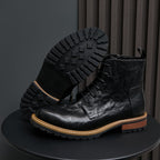 Men's black leather boots with pointed toe, lace-up design, and side zipper.