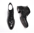 Black lace-up dress boots showing side profile and patterned leather texture