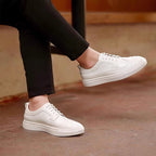 Men's genuine leather sneakers, white lace-up low profile with perforated toe and clean panels.