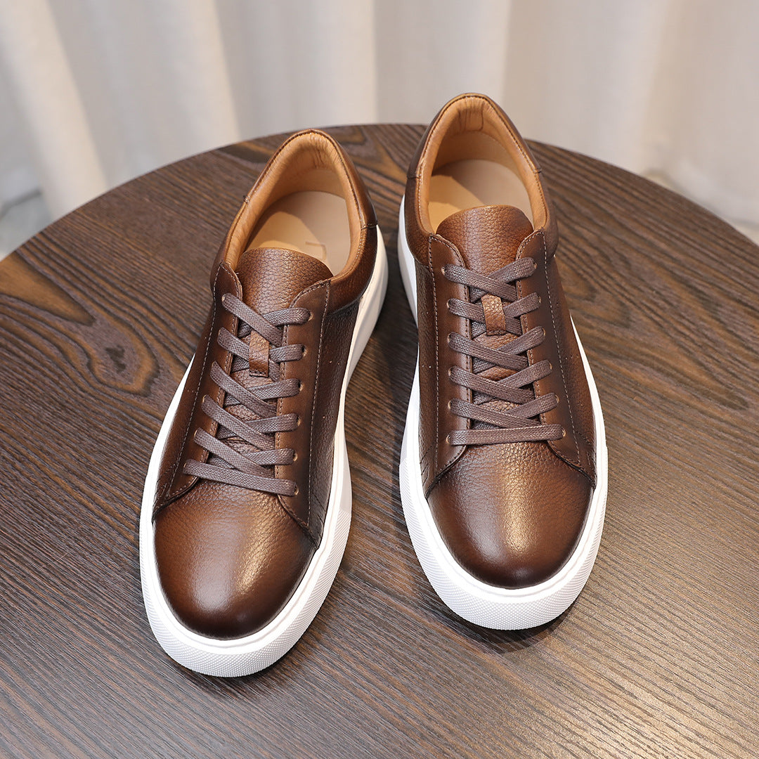 Dark brown leather sneakers shown top view with lace-up closure and white soles.