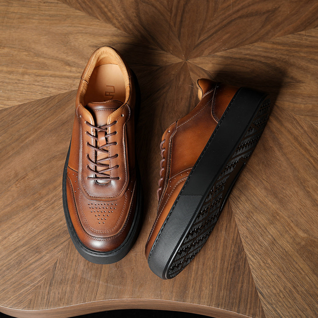 Dark brown leather sneakers with black side panel detail and lace-up closure.