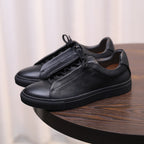 Men's genuine leather sneakers, black low-top with lace-up closure and rubber sole