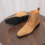 Tan suede chukka boots with visible treaded outsole and lace-up upper