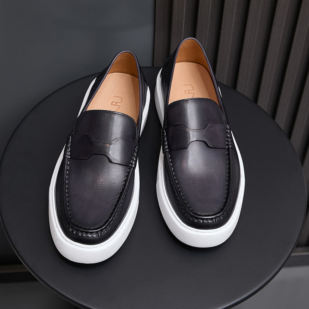 Black leather slip-on sneakers with moccasin seam detailing and white platform sole