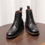Black leather ankle boots with lace-up closure, side zipper, and brown-trim outsole