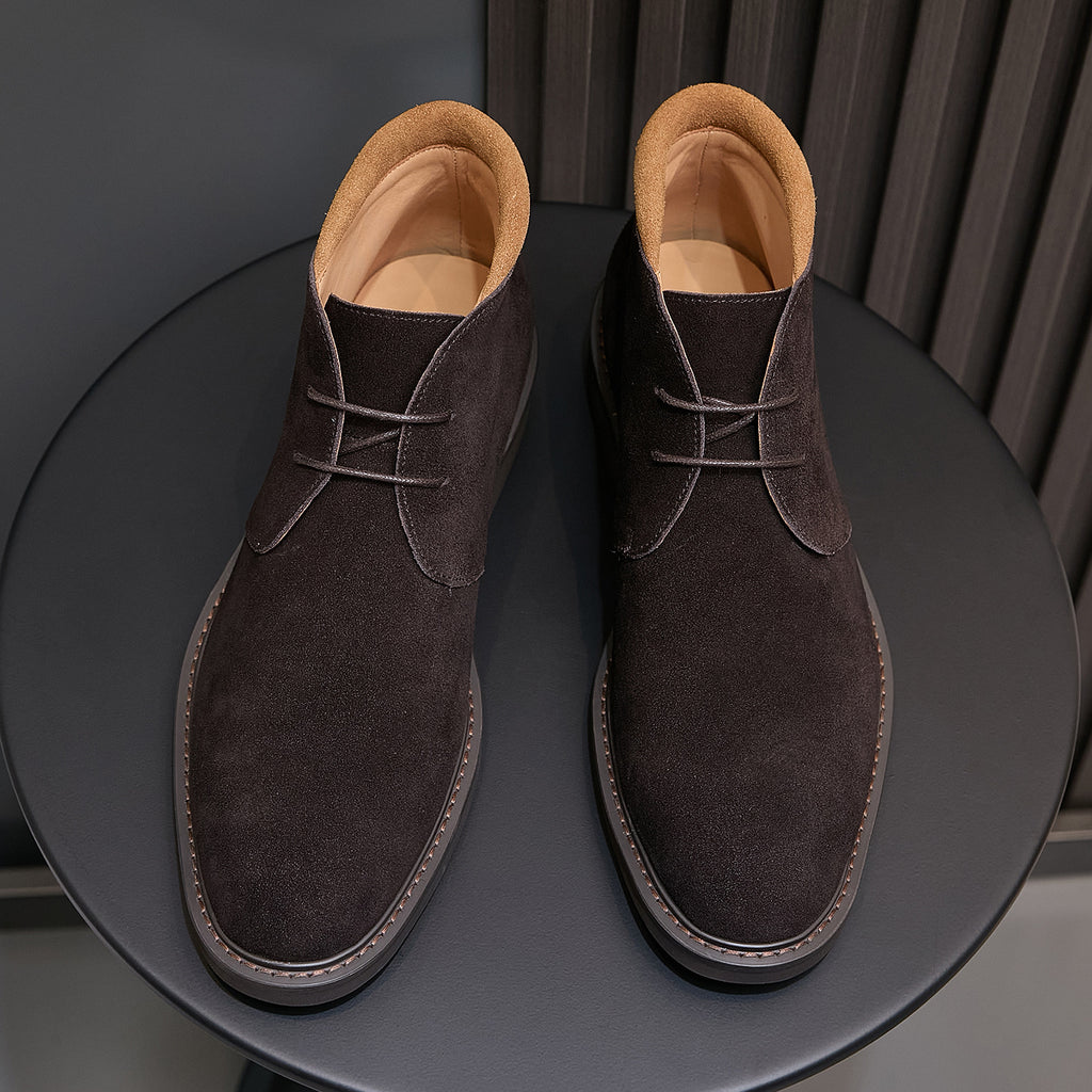 Dark brown suede lace-up chukka boots, front view, with tan inner lining