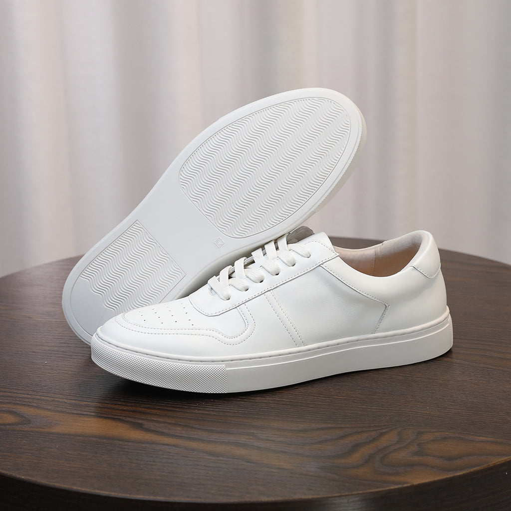White men's leather sneakers, outsole side showing textured tread