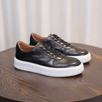 Men's leather sneakers, brown, lace-up with white rubber sole and rounded toe.