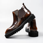 Dark brown leather Chelsea dress boots with elastic gore, brogue design, and block heel sole