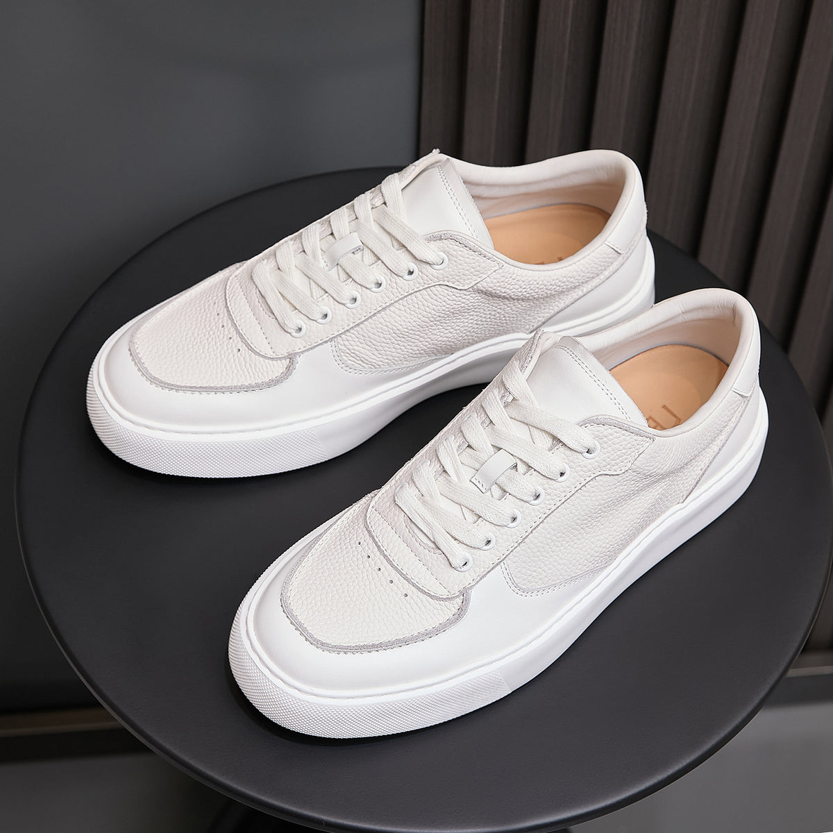 White genuine leather sneakers shown from top, with lace-up eyelets