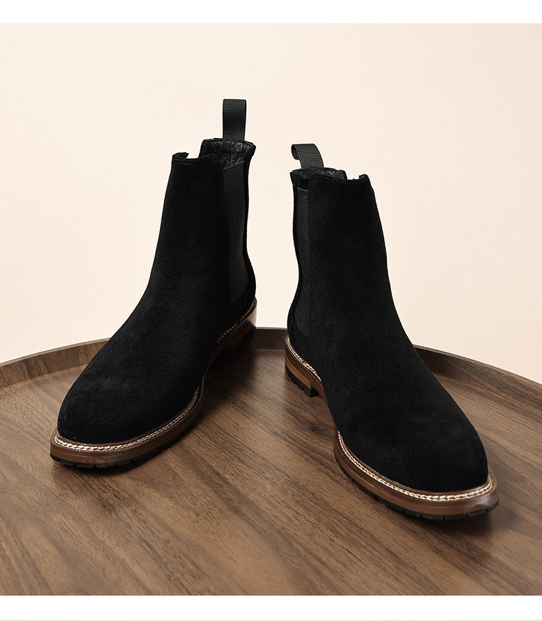 Pair of black Chelsea dress boots with elastic gore and stitched midsole trim