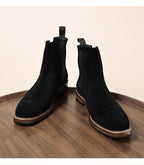 Pair of black Chelsea dress boots with elastic gore and stitched midsole trim