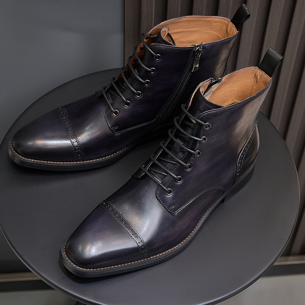 Men's leather lace-up dress boots pair showing interior lining and wingtip seams