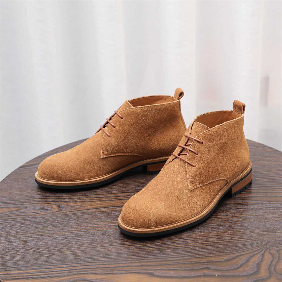 Tan-brown suede chukka boots with lace-up closure, low heel, and tread sole.