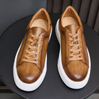 Men's brown leather sneakers, front view pair with tan laces and white platform sole
