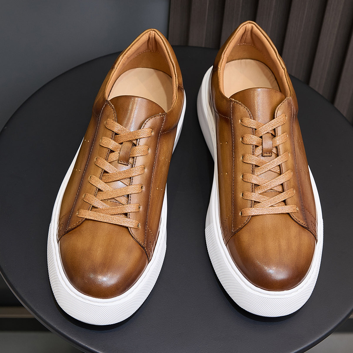 Men's brown leather sneakers, front view pair with tan laces and white platform sole