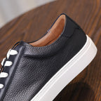 Men's genuine leather sneaker side profile with padded collar and white sole