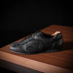 Men's black leather sneakers with lace-up front and textured toe panel