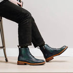 Dark green leather lace-up ankle boots with pointed toe, contrast welt and rubber sole
