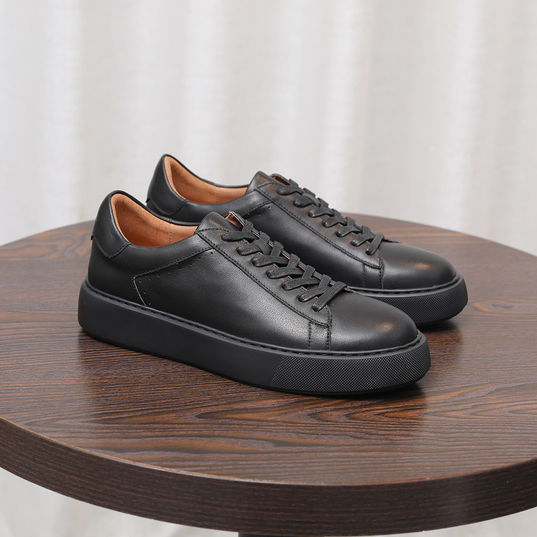 Men's black leather sneakers with lace-up front and stitched panels, cushioned platform sole