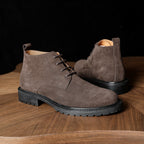 Men's suede chukka boots, plain toe, lace-up closure, dark taupe, rugged rubber sole.