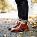 Men's tan-brown leather lace-up chukka boots, plain toe, cuffed jeans