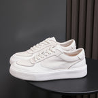 White genuine leather sneakers with stitched panels and flat lace-up tongue