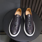 Men's leather sneakers, dark purple with white sole and tan insole lining.