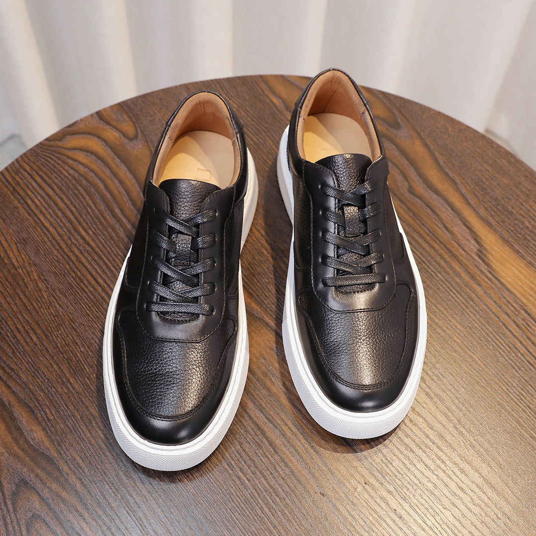 Men's leather sneakers, black, pair view with lace-up uppers and white soles.