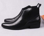 Black leather Chelsea dress boots, side profile with low block heel and pull tab