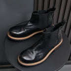 Men's pointed-toe suede Chelsea dress boots, black, angled pair view
