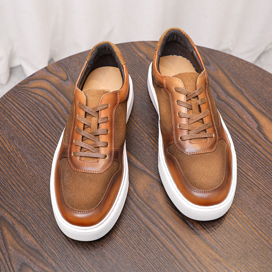 Pair of brown leather lace-up sneakers with padded collar and white rubber sole