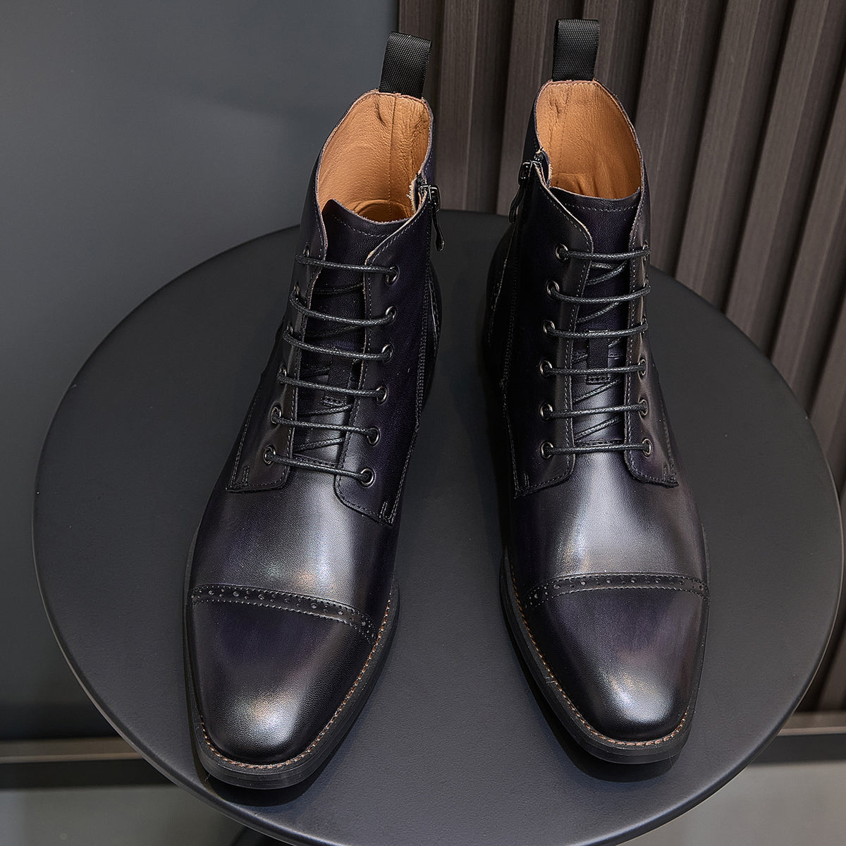 Men's dark leather lace-up dress boots pair from front view with pointed toe