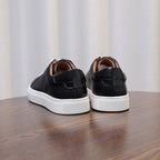 Men's genuine leather sneakers, rear view of black uppers with white soles