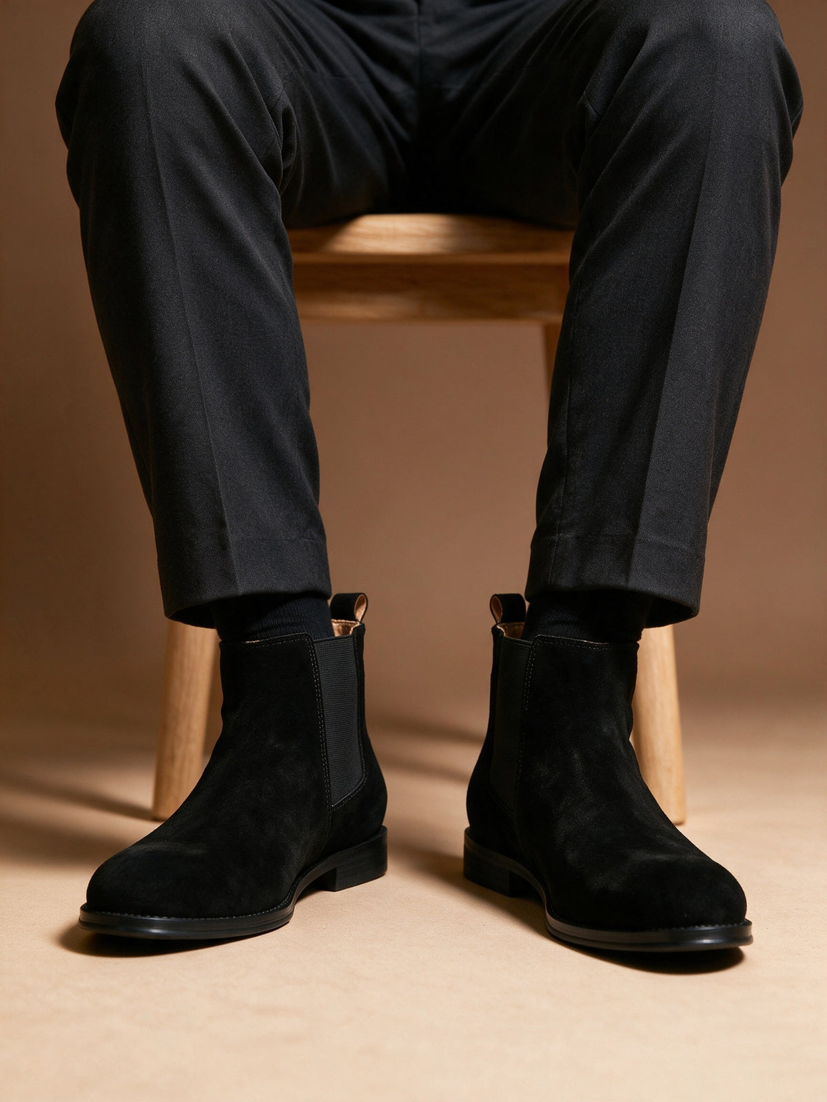 Men's pointed-toe suede Chelsea dress boots, black, worn with rolled trousers