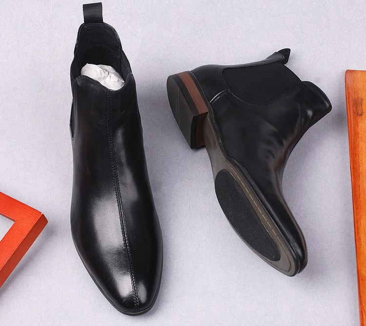 Black leather Chelsea boots with low block heel and dark rubber outsole.
