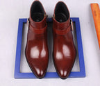 Men's burgundy leather dress boots pair on blue box, side zipper and thick sole.